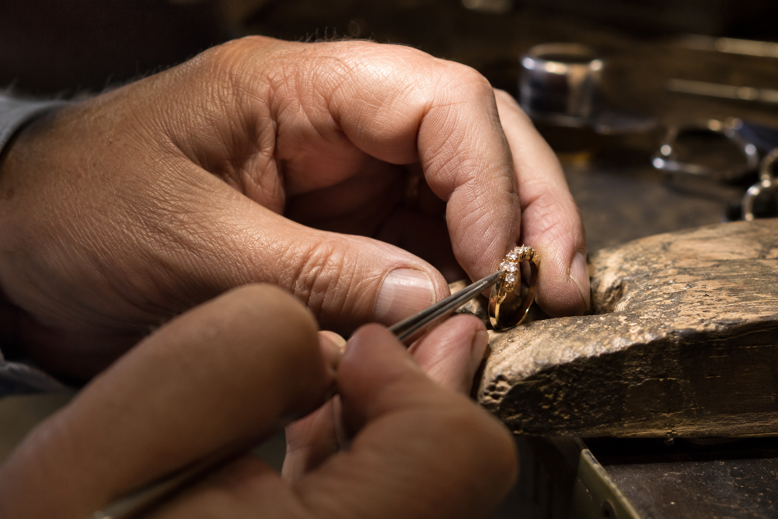 Jeweler repairing a ring with stones