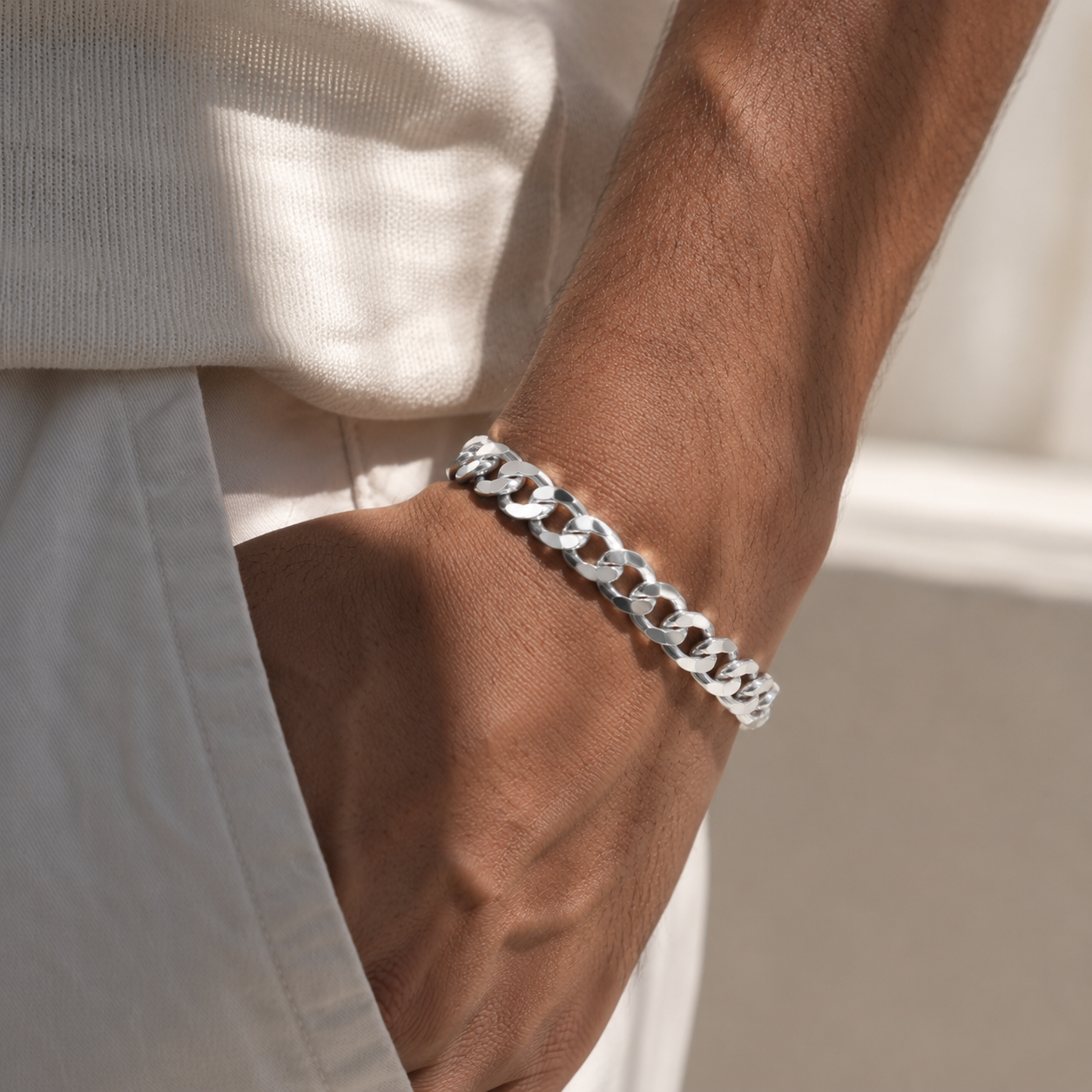 Men's silver chain bracelet worn on the wrist